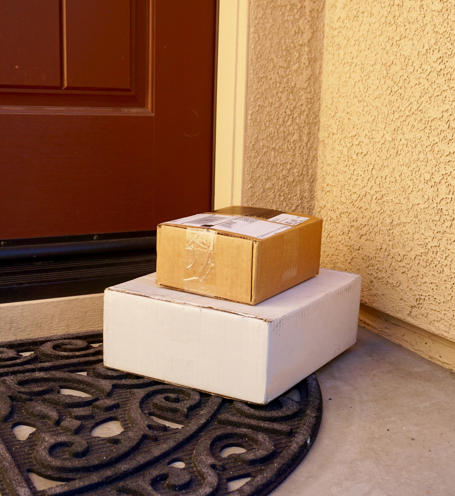 Delivered packages by a front door at a home